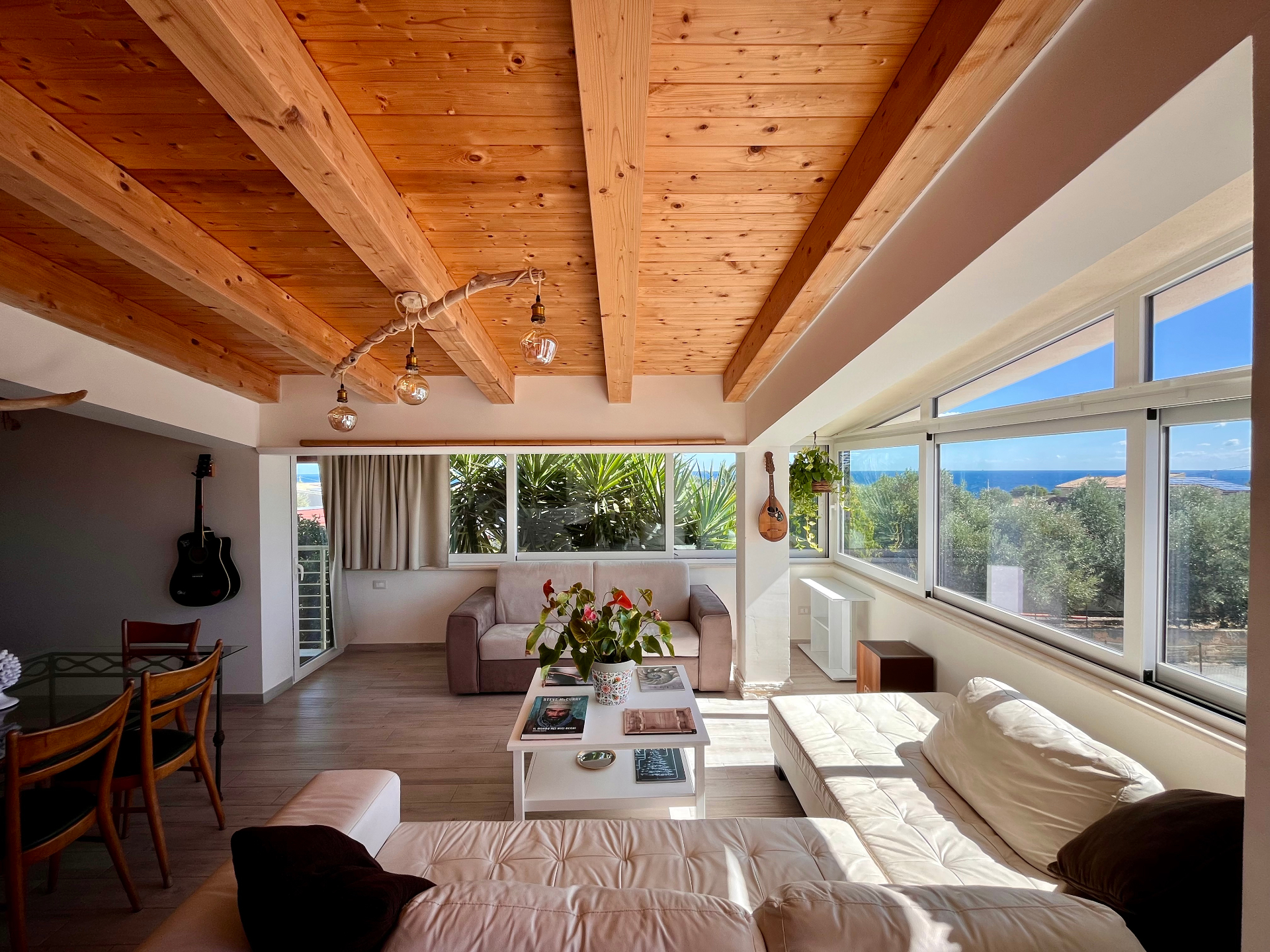 Sea view living room at The Blue Window Sicily apartment, with wide bright windows