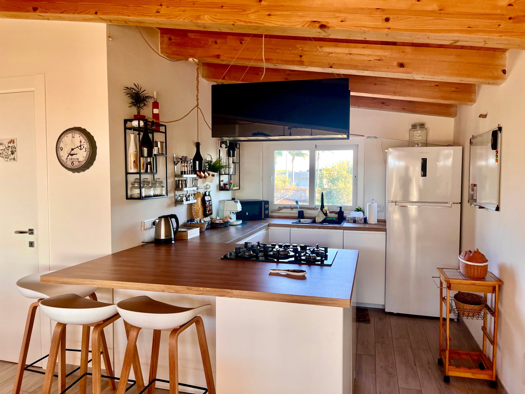 Open kitchen and living space at The Blue Window sea-view apartment, South-East Sicily