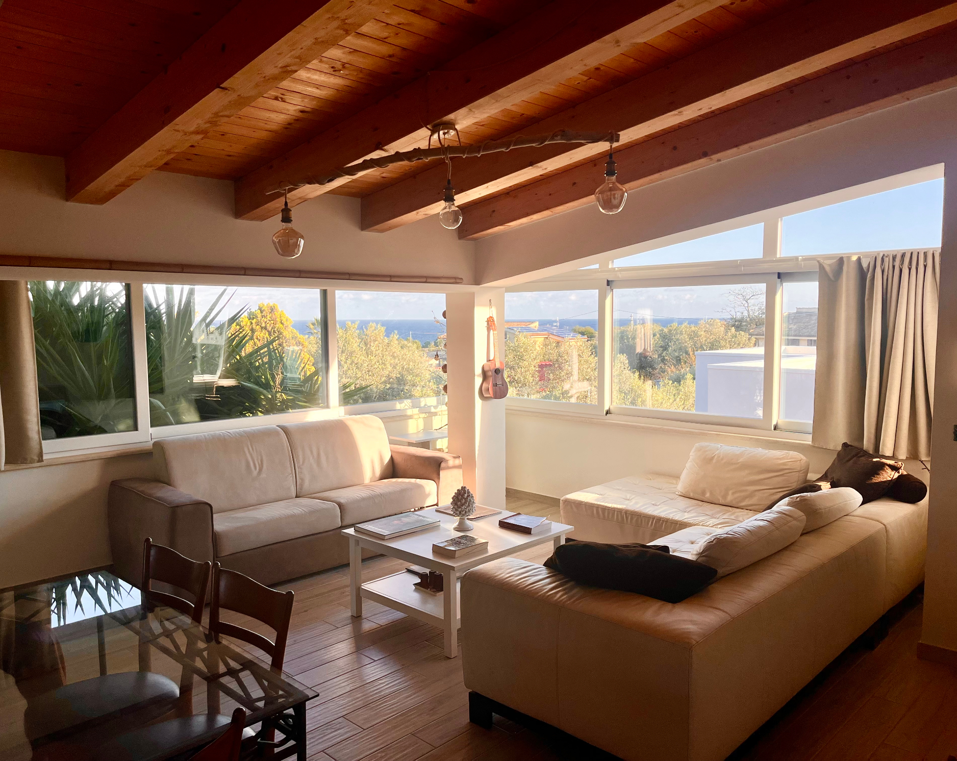 Sea view living room at The Blue Window Sicily apartment, with wide bright windows