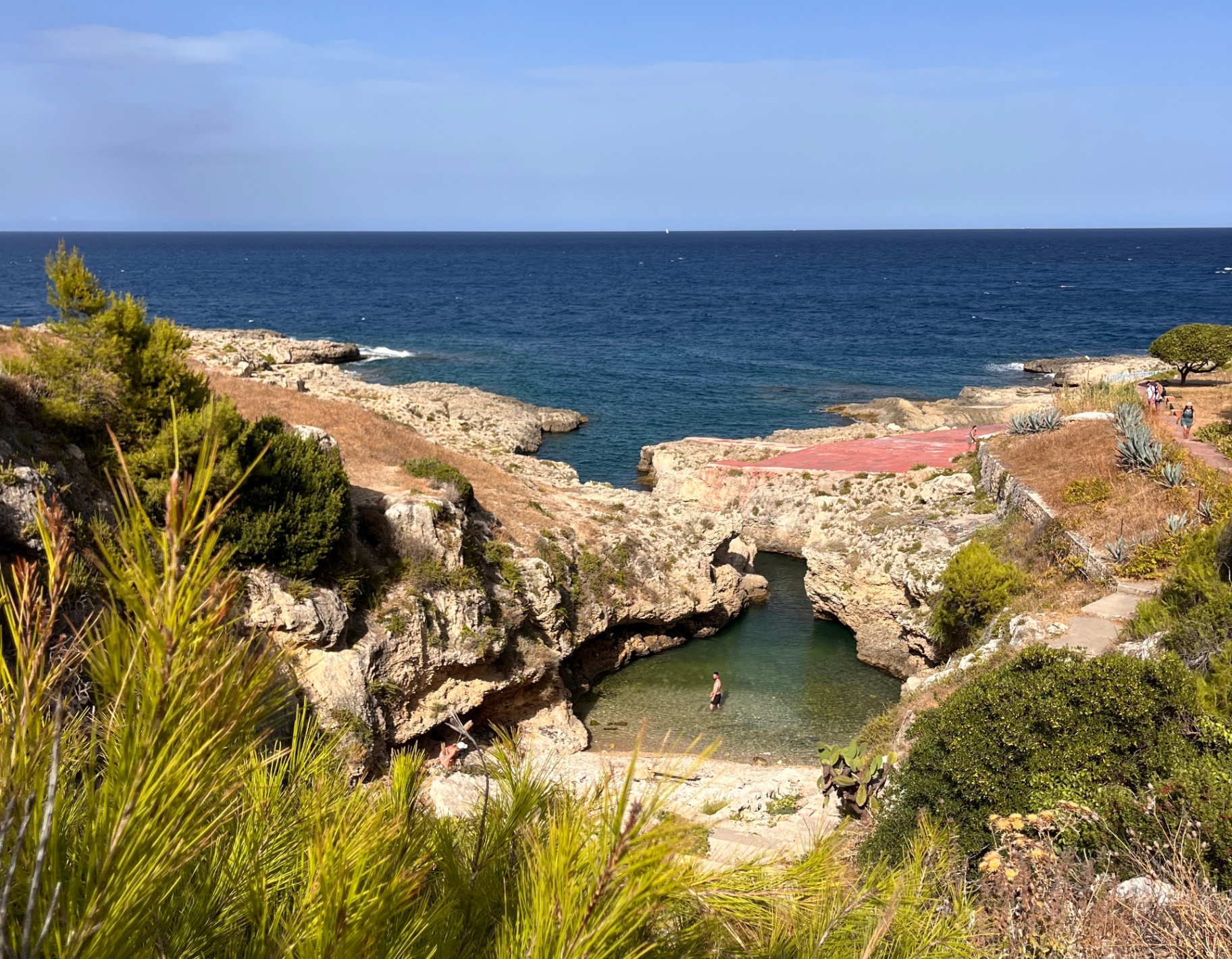 Sicilian coastline with a natural rock arch and turquoise pool, 300 meters from the Blue Window