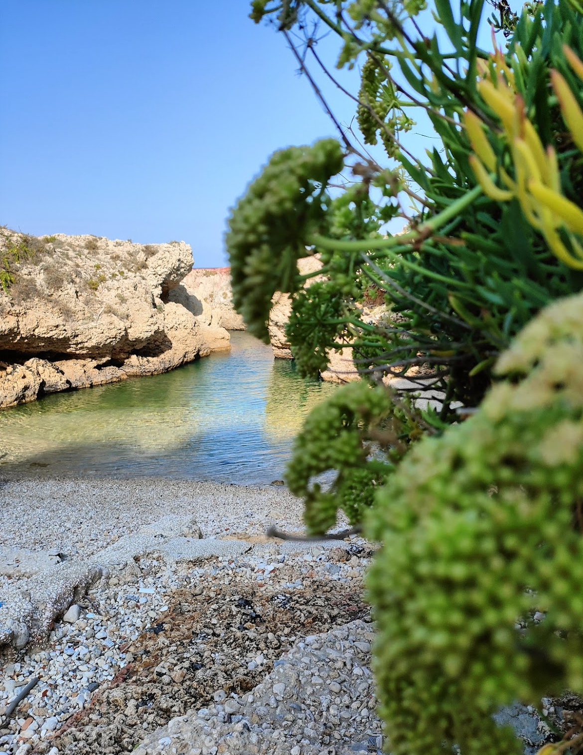 Turquoise water in a secluded rocky cove along the Augusta and Brucoli coastline